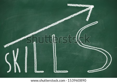 word Skills hand written on the chalkboard with rising arrow graph