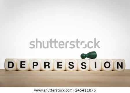 Depression concept with green pawn given up on top of toy dice