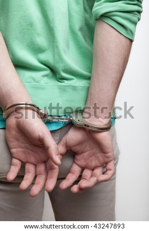 Man with hands cuffed behind his back