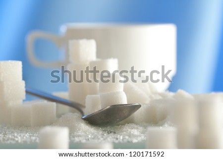 a spoonful of sugar cubes with shallow depth of field
