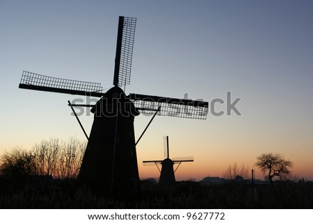 silhouettes of two windmills in Kinderdijk, Holland