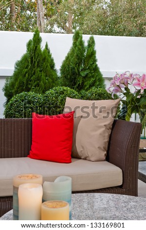 Outdoor patio seating area with nice Rattan sofa at sunset