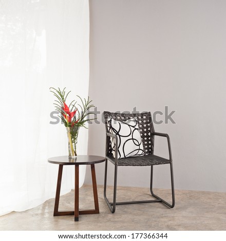 Garden furniture chair in simple setting and side table