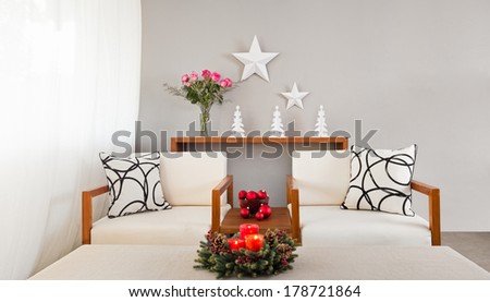 White sofa seat in Christmas setting and with flowers
