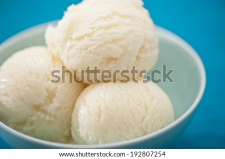 Vanilla ice cream cup over blue background