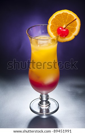 Tequila sunrise Cocktail in front of different colored backgrounds