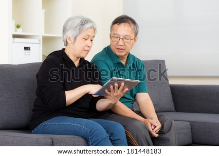 Asia old couple using tablet