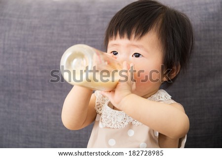 Asia baby girl feeding with milk bottle
