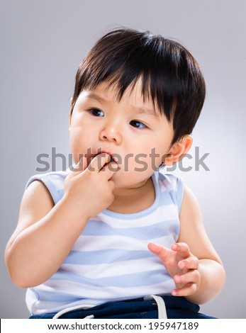 Baby sucking finger into mouth