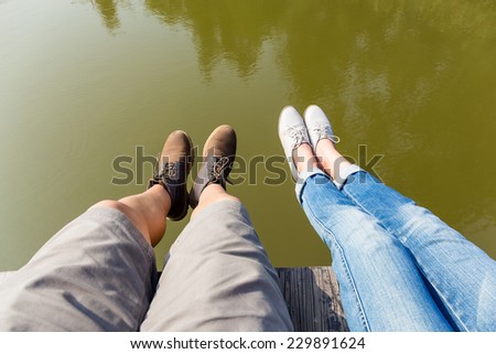 Couple legs on water lake