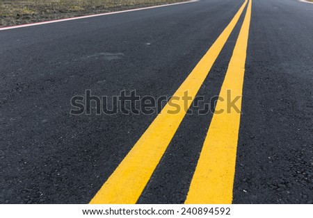 Asphalt road with pair of yellow line