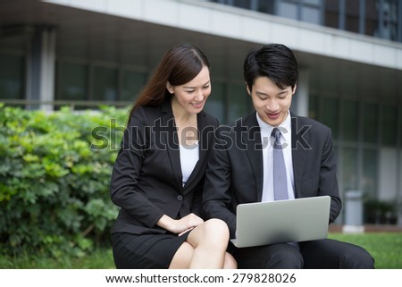 Business man and woman working together at oudoor