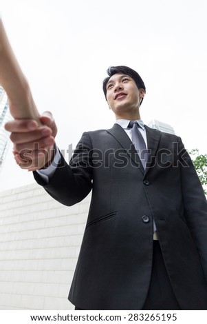 Businessman hand shaking with other