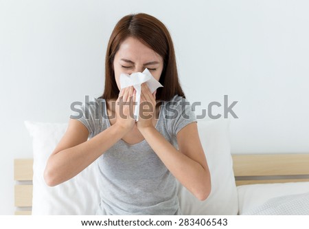 Woman sneeze on bed