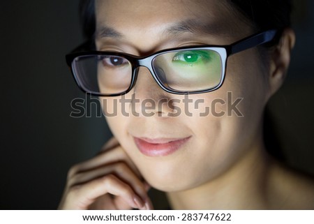 Asian woman looking at the screen at night