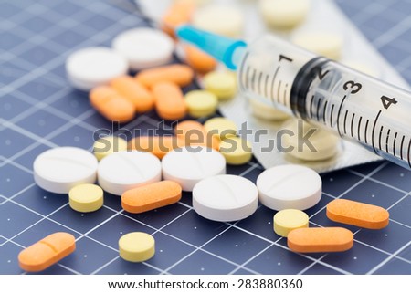 Pills and injection syringe