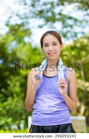 Asian woman with towel on shoulder after doing exercise