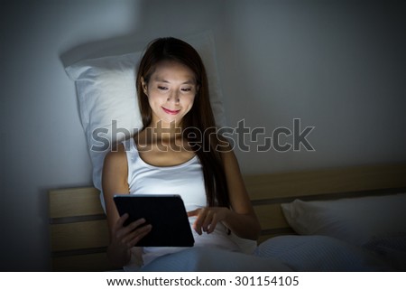 Woman checking email before bed time