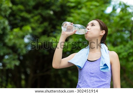 Sporty Woman drink water at outdoor