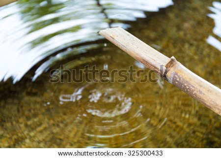 Bamboo fountain with water wave