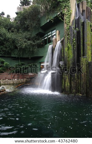 a chinese restaurant with waterfall outside