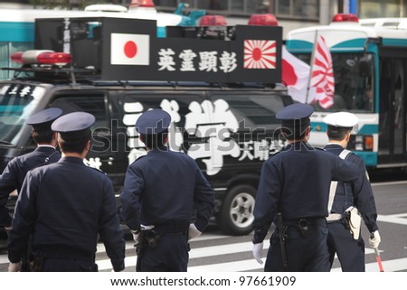 TOKYO - MARCH 11: Police stopping right-wing protesters near the Imperial Palace on March 11, 2012 in Japan. Radicals often use public holidays and anniversaries to promote nationalist propaganda.