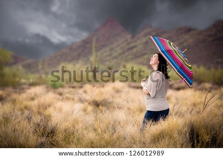 Woman Walking in the Desert During a Rain Storm.