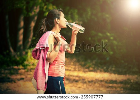 a girl drinks water after sport