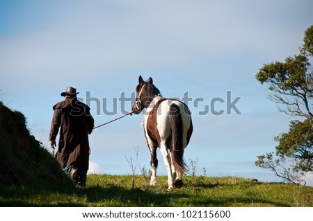 Farmer leading horse