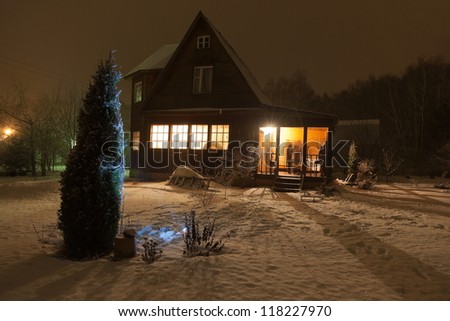 Russian county house (dacha) and decorated Christmas tree. Moscow region. Russia.
