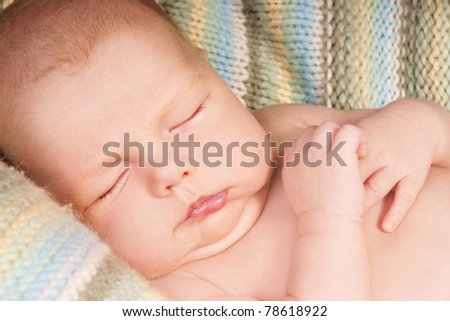 Close-up portrait of new born cute sleeping baby boy, studio shot