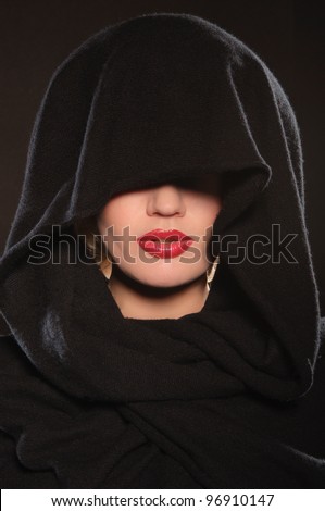 portrait of beautiful woman in cape on dark background