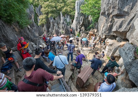 KUNMING - OCT 1: crowd of people travel during national holiday on October 1, 2012 in Kunming, China. More than 20.000 people visit sites like the Kunming Stone Forest daily.