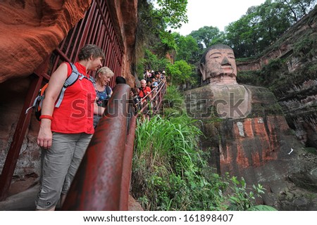 LESHAN, CHINA - OCT 7: tourists visit world\'s largest Buddha during Chinese National holiday on October 7, 2012 in Leshan, China. During this holiday around 740 million trips will be made by Chinese people.