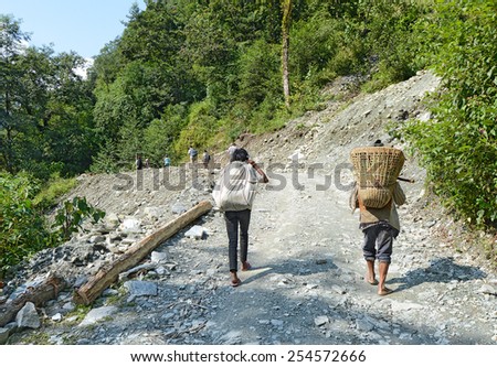 POKHARA - NOVEMBER 16: Nepali trekking porters on the trail on November 16, 2014 in Pokhara, Nepal. Porters are an invaluable part of a trekking with a salary of only 4-5 US dollars per day.