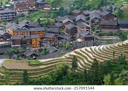 PINGAN, CHINA - MAY 20: View of village and rice terraces on May 20, 2014 in Pingan, China.The area is constructed in the early Yuan Dynasty (1271-1368 AD) and ranked as a major tourist site in China.