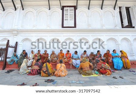 DELHI, INDIA - MAY 6: Indian worshippers rest in front of Hindu Mandir temple on May 6, 2014 in Delhi, India. Hinduism is the major religion in India with over 79 percent believers.