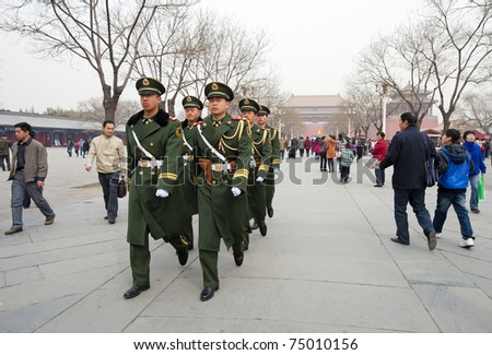 BEIJING - APRIL 2: Chinese soldiers prepare for the national flag ceremony on April 2, 2010 in Beijing, China. Here soldier are marching to the flag pole.