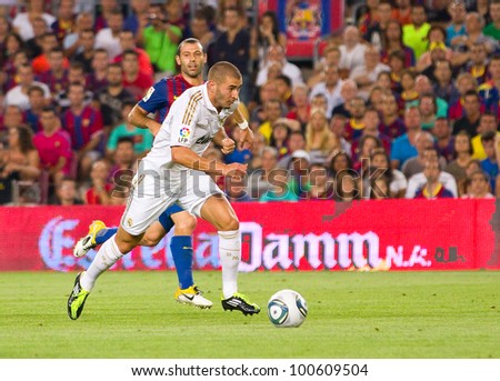 BARCELONA - AUGUST 17: Karim Benzema in action during the Spanish Super Cup final match between FC Barcelona and Real Madrid, 3 - 2, on August 17, 2011 in Camp Nou stadium, Barcelona, Spain.