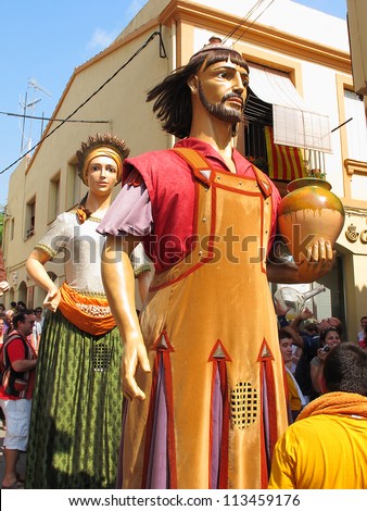 ALELLA, SPAIN - SEPTEMBER 09: Some unidentified people at La Verema Wine Festival, a traditional party of Alella, with a traditional parade of Giants, on September 9, 2012 in Alella, Barcelona, Spain.