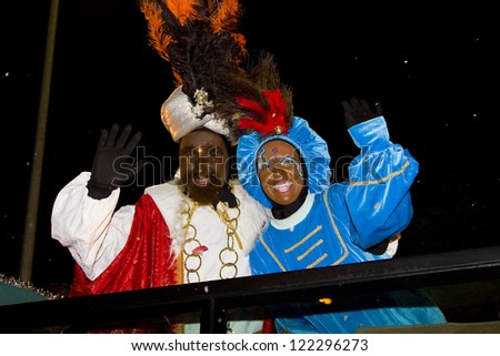 BARCELONA - JANUARY 5: Balthazar King (L) at the Biblical Magi Three Kings parade, who give toys to the children. Is a traditional spanish celebration. January 5, 2012 in Alella, Barcelona, Spain.