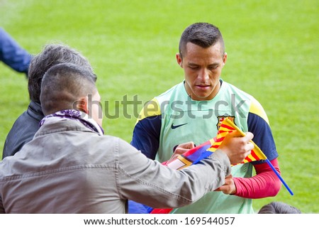 BARCELONA, SPAIN - JANUARY 3: Alexis Sanchez sign autographs at FC Barcelona team in open doors training session at Mini Estadi stadium, with 13,200 spectators, on January 3, 2014 in Barcelona, Spain.