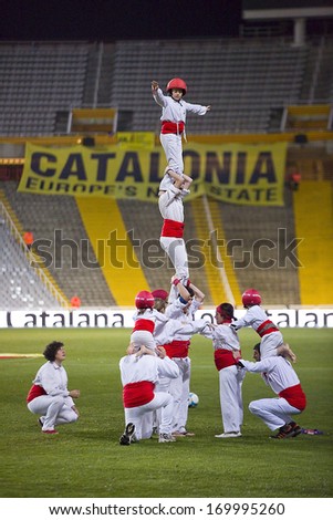 BARCELONA, SPAIN - DECEMBER 30: Human tower spectacle before the friendly match between Catalonia and Cape Verde, 4-1, on Decembre 30, 2013, in Olympic stadium Lluis Companys, Barcelona, Spain.