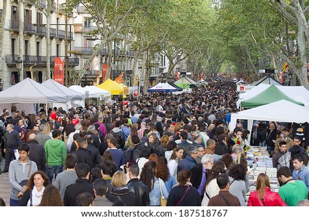 BARCELONA - APRIL 23: Diada de Sant Jordi or Saint George\'s Day, a famous Catalan celebration, on April 23, 2013, in Barcelona, Spain. Traditionally, men gave women roses, and women gave men a book.