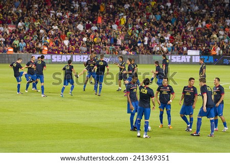 BARCELONA - AUGUST 17: FCB players in action at the Spanish Super Cup final match between FC Barcelona and Real Madrid, 3 - 2, on August 17, 2011 in Camp Nou stadium, Barcelona, Spain.