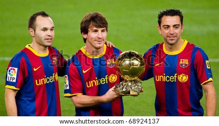 BARCELONA - JANUARY 12: Iniesta, Messi and Xavi offering the Gold FIFA World Player Trophy to the soccer supporters of Football Club Barcelona. January 12, 2011 in Nou Camp stadium, Barcelona (Spain).