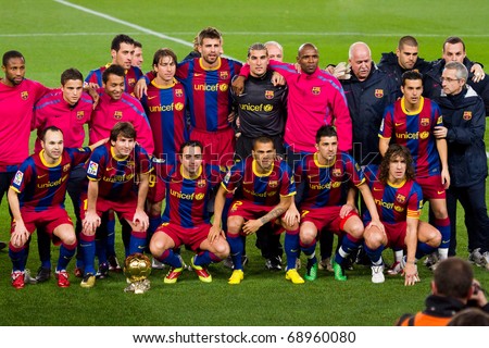 BARCELONA - JANUARY 12: Football Club Barcelona players with the FIFA World Player Trophy of Leo Messi. January 12, 2011 in Nou Camp soccer stadium, Barcelona (Spain).