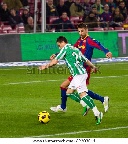 BARCELONA - JANUARY 12: Camp Nou stadium, soccer Spanish Cup match: FC Barcelona - Real Betis, 5 - 0. In the picture, Gerard Pique and R. Castro in action. January 12, 2011 in Barcelona (Spain).