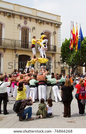 BARCELONA - MAY 1: Some unidentified people called Castellers do a Castell or Human Tower, typical tradition in Catalonia, on May 1, 2011 in Mollet del Valles, Spain.