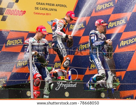 BARCELONA - JUNE 5: Casey Stoner (1st), Jorge Lorenzo (2nd) and Ben Spies (3dr) celebrating their trophies in the podium after the MotoGP Grand Prix of Catalunya, on June 5, 2011 in Barcelona, Spain.